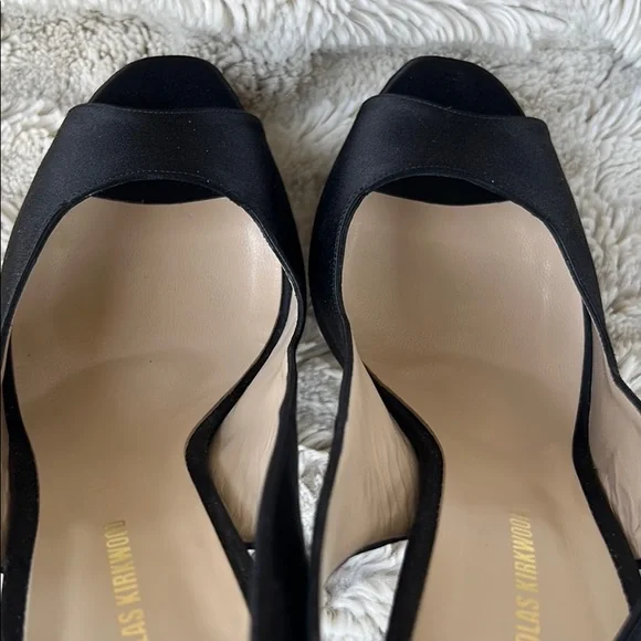 Nicholas Kirkwood black sling-back heals with signature pearl platform.